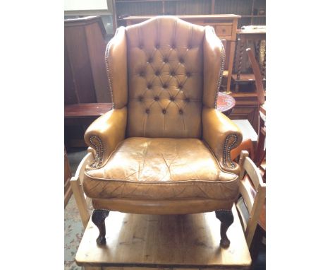 MUSTARD YELLOW BUTTON LEATHER ARMCHAIR WITH CARVED MAHOGANY FEET. W83CM