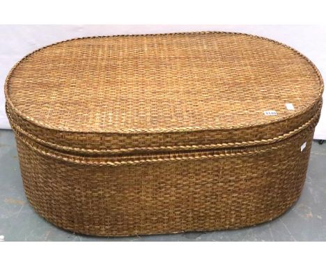 A large canework hamper of oval form, with hinged rigid lid, 110 x 71 x 45 cm H. Not available for in-house P&amp;P, contact 