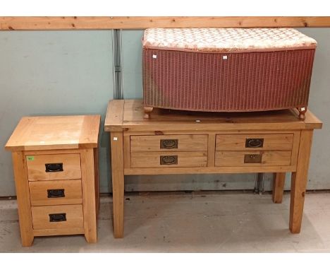 A modern light wood bedside chest of three drawers with drop handles, height 66cm, width 48cm, depth 40cm, and a Lloyd Loom o