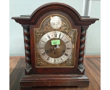 Junghuns Bracket Clock, oak case with barley twist columns, eight-day movement with brass and silvered dial.