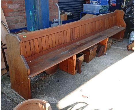 A large long 19th century pitch pine pew.