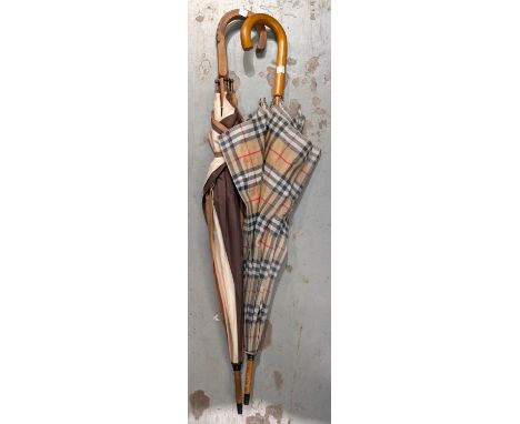 A vintage Burberry umbrella and another vintage umbrella