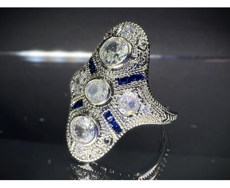 An Art Deco style white metal ring with clear and blue stones