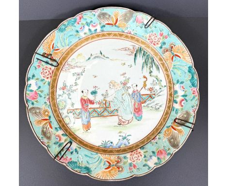 A Chinese late 19th century famille verte porcelain plate genre scene with ornate border decorated with butterflies 34cm diam