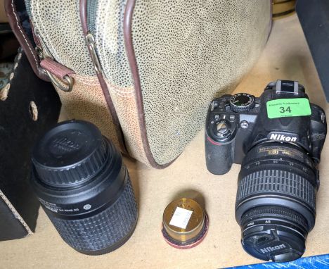 A Nikon DX D3100 SLR Camera with bag + a Victorian lens.