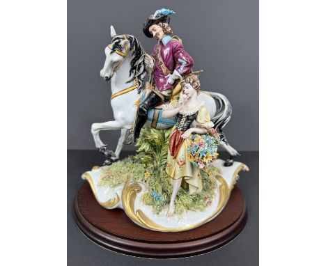 A Capodimonte porcelain figure group, signed G.PELLATI, 20cm, with hardwood base.