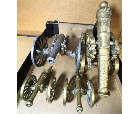 A large brass display cannon with dragon decoration and a brass horse and cart, pottery figures