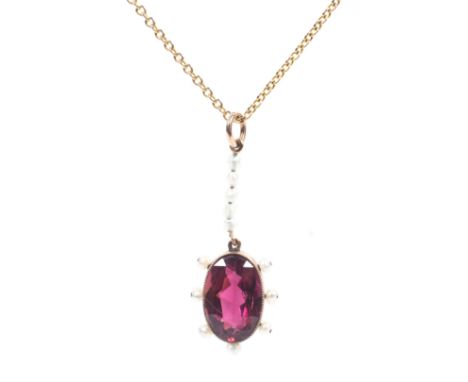 A yellow metal garnet and seed pearl pendant on a 9ct marked chain link necklace. 2.6g. 