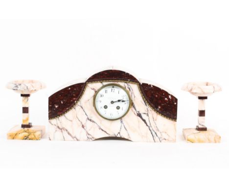 A French Art Deco marble striking mantel clock garniture, all in veined pale pink and red marble, the arched rectangular cloc