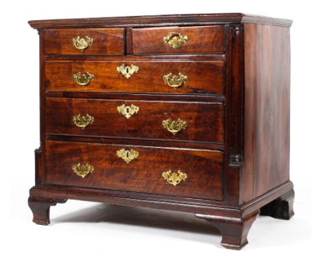 A Georgian mahogany chest of drawers, with column supports, with two short and three graduated long drawers, on ogee bracket 