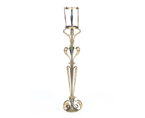 A Victorian brass ornate standard lamp in the style of WAS Benson of foliate scroll form, with cylindrical fitting to top and