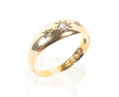 An 18ct gold and diamond gypsy ring, star set with three single cut diamonds, size O, 3.3 grams