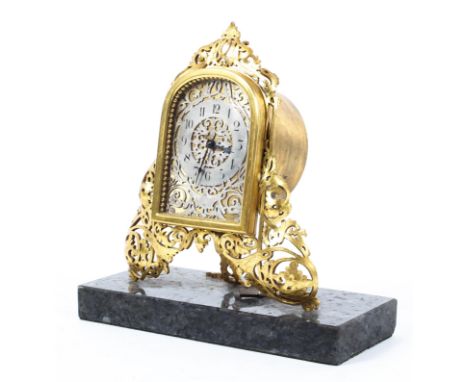 A French brass and gilt-metal mounted mantel clock, late 19th/early 20th century, with arched rectangular frame to pierced si