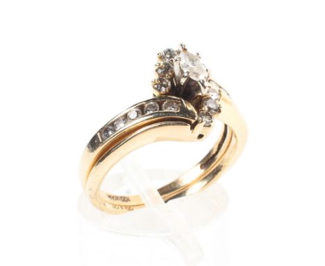 A 14ct gold and diamond double interlocking dress ring central marquis cut diamond with single cut diamond accents and should