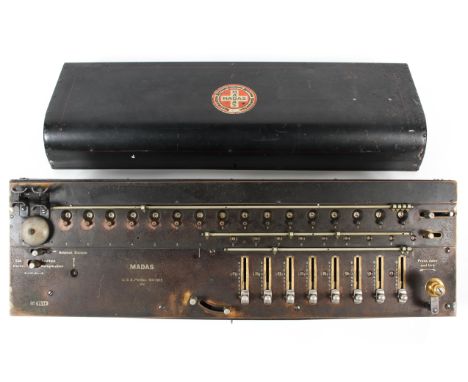 A Madas (USA) calculating machine, with manually operated drum calculating mechanism in black painted brass and steel, with b