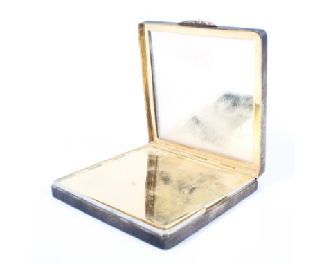 A vintage silver compact, of square, engine turned form, opening to reveal mirror and concealed compact under gilt lid, hallm