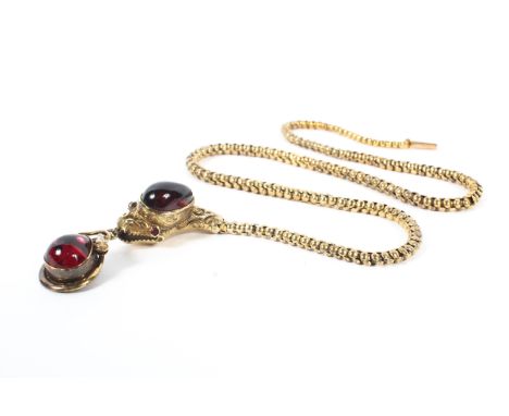 A yellow metal and garnet serpent necklace circa 1880, the head set with garnet cabochon and ruby eyes on a highly articulate