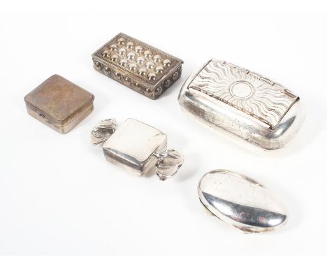A collection of five silver and white metal pots, including a British import silver pill pot in the form of a sweet, another 