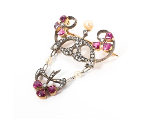 An unmarked Art Nouveau yellow, white metal, diamond, ruby and pearl set pendant. with free cut rubies, rose cut diamonds and