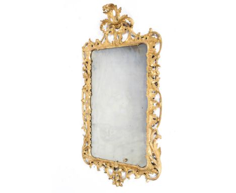 A George III giltwood and gesso rococo mirror, of rectangular form, with pierced shell and scrolling acanthus crest and mantl