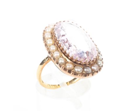 An 18ct gold rose quartz and seed pearl dress ring, the central faceted rose quartz with a surround of split pearls, size K, 