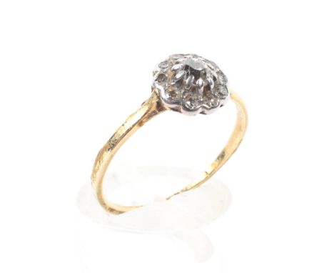 An unmarked  yellow metal and diamond flower ring, centrally set with old cut diamond with a surround of 10 old cut diamonds.