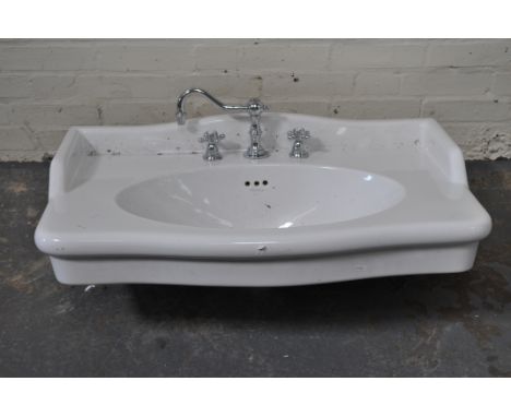 Large vitreous hand-wash basin and fittings.