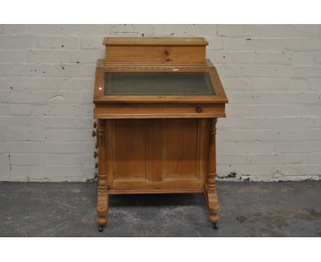 Stripped pine Davenport, the hinged compartment, tooled leather slope front, fitted with end drawers, width 61cms and a beech