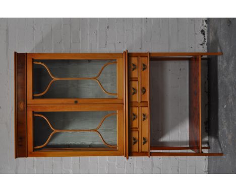 Reproduction yew wood display cabinet, two glazed doors to the upper section, fitted with six drawers to the frieze, over an 