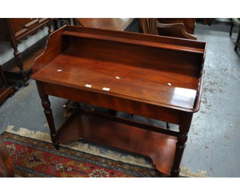 Victorian mahogany wash stand, top with a three quarter gallery rounded corners and a moulded edge, plain frieze, turned legs