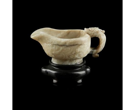 CARVED JADE ARCHAISTIC POURING VESSEL, YIthe deep vessel carved with a pouring lip to one end and a kuilong handle to the oth