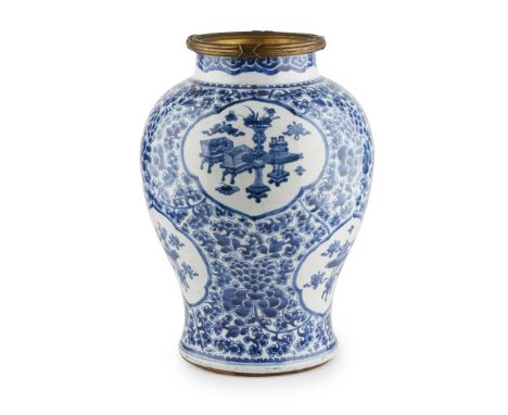 ORMOLU-MOUNTED BLUE AND WHITE JARKANGXI PERIOD decorated with six lobed panels arranged in two rows enclosing censers, jardin