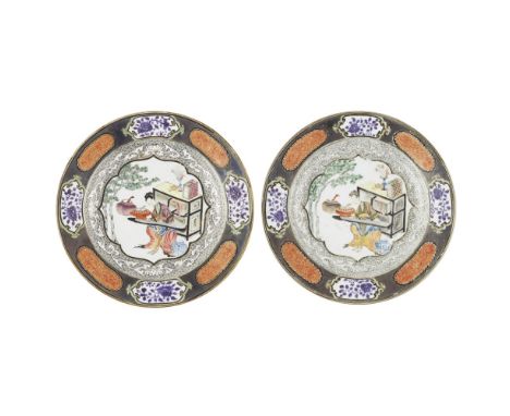 PAIR OF EN GRISAILLE AND FAMILLE ROSE DISHESYONGZHENG PERIOD each decorated to the centre with a lobed panel enclosing a seat