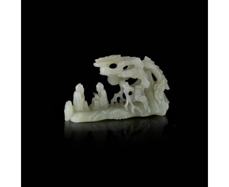 CARVED CELADON JADE BRUSH RESTcarved with two scholars engaged in conversation beside a gnarled pine tree, a deer nestled nea