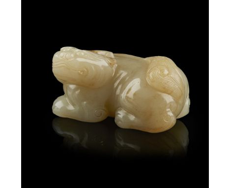 CELADON JADE MODEL OF A BIXIEthe recumbent beast carved in the round with its head turned sideward, the knobby spine arched t