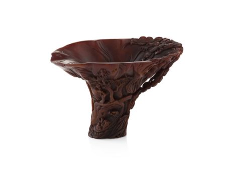 FINELY CARVED RHINOCEROS HORN LIBATION CUPQING DYNASTY, 18TH/19TH CENTURY carved in high relief around the exterior with figu
