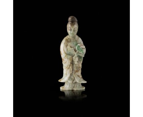 JADEITE FIGURE OF HE XIANGUEARLY 20TH CENTURY the immortal shown holding a large lotus spray, the hair arranged into a high c