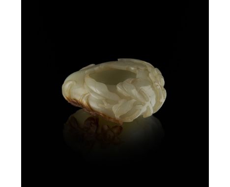 CELADON JADE 'PEACH' BRUSH WASHERQING DYNASTY, 19TH CENTURY in the form of a hollowed peach, the exterior carved with outstre