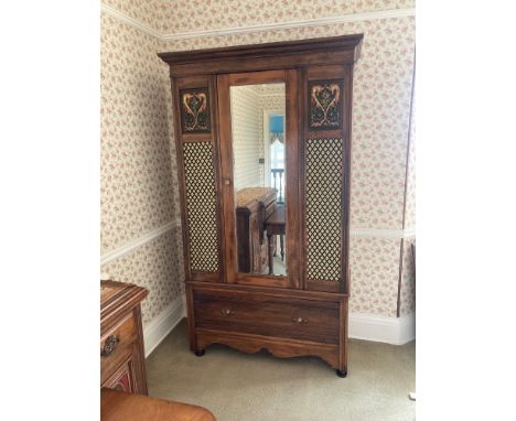 A Victorian walnut single mirrored door wardrobe with carved, painted and material panels and porcelain and brass knob and ha