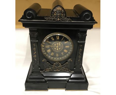 A slate mantle clock with decorative panels and roman numerals. Marked to face Dent Strand London. 41cms h x 31cms w x 17.5cm
