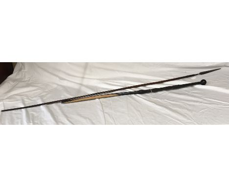 An African carved ebony walking stick with knob handle 96cms l together with an African tribal spear with wood shaft with met