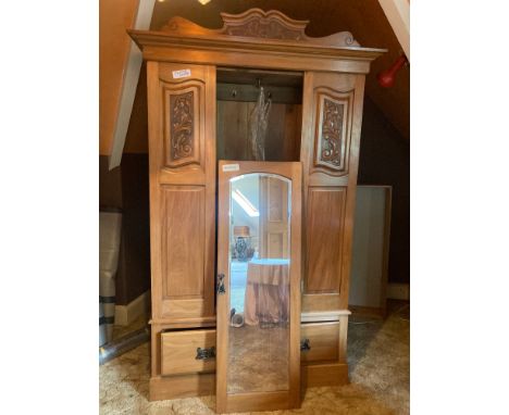 A Victorian light walnut single mirrored door wardrobe with carved panels and art nouveau handles. 212cms h x 117cms w x 38cm