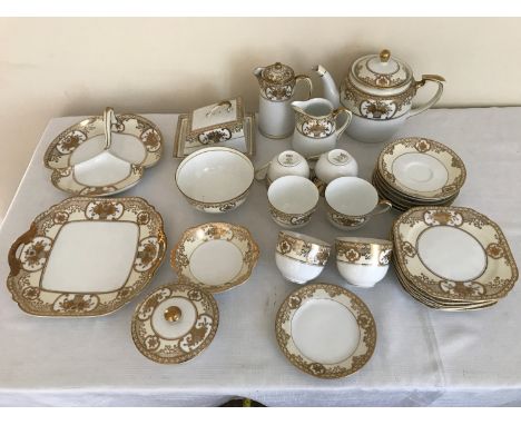 A Noritake gilt decorated tea service, 28 pieces comprising: 6 cups and saucers, 6 side plates 16.5cms d, teapot, hot water p