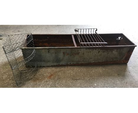 A large galvanised metal trough 186cms l x 49cms w x 40cms h together with a wire mesh corner shelf 66cms h, a cast iron gril