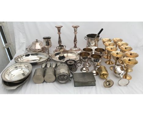 A quantity of plated ware comprising silver plated candle sticks 25cms h , tableware, lidded serving dishes, pewter box, gobl