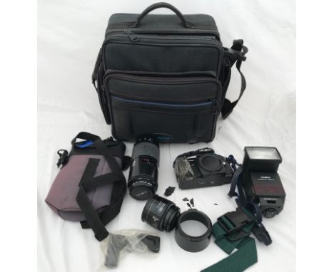 A Minolta 7000 camera kit with bag and accessories including Minolta AF lens 70-210, AF lens 50, flash unit and straps.Condit