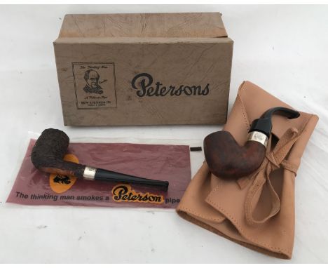 Peterson Pipes, one a Centenary 1975, sterling silver collar with leather pouch and another with sterling silver collar.Condi