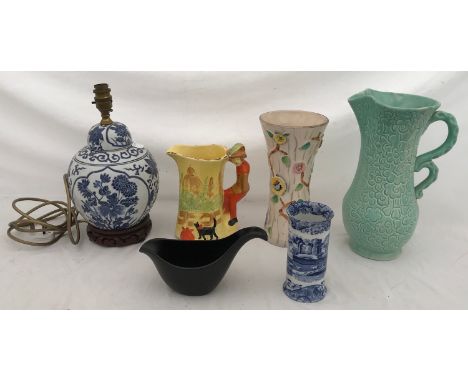 A mixed lot of ceramics to include a blue and white lamp on a wooden base, an Arthur Wood jug and vase. a green shorter jug, 