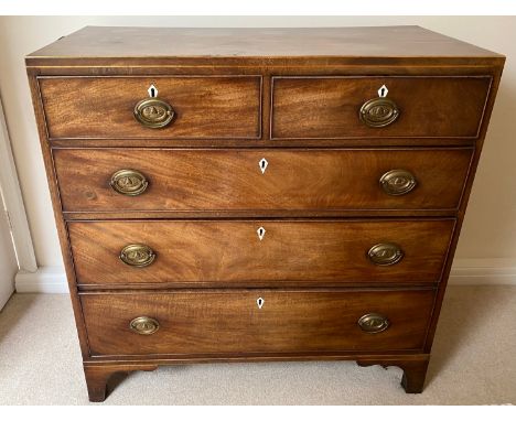 A 19thC mahogany chest of drawers on bracket feet. 2 short over 3 long drawers with ivory escutcheons and brass drop handles.