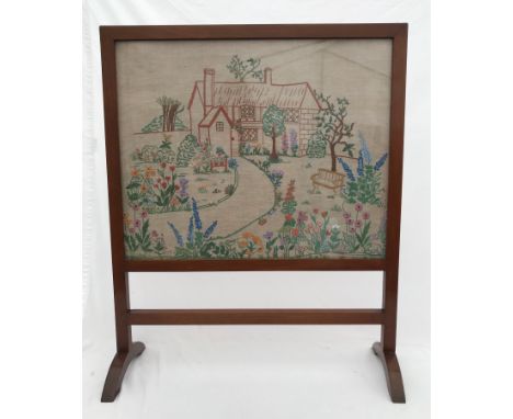 A mahogany framed firescreen with needlework panel cottage garden design. 71cms h x 58cms w.Condition ReportChip to wood on r